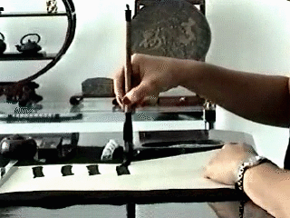 A student holding the brush upright