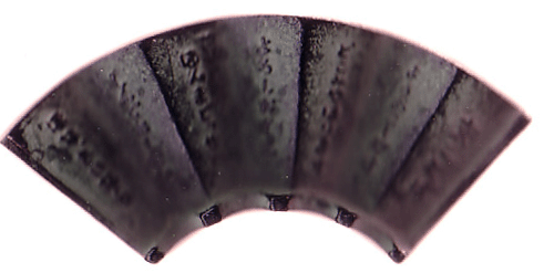 This is a close-up of a sumioki (Sumi Rest). This has an accordion surface like a folding fan. This shape allows that if there is a little water on the ink stick the water will either run off or dry quickly.